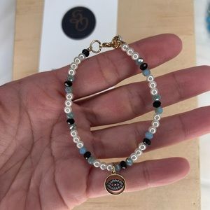 bracelet with mini pearls and evil eye charm